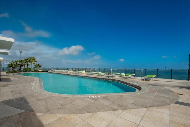 pool with a patio and fence