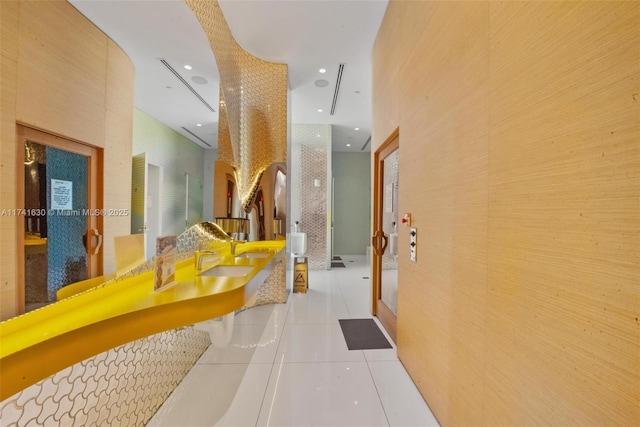 bathroom featuring double vanity, recessed lighting, a sink, tile patterned flooring, and walk in shower