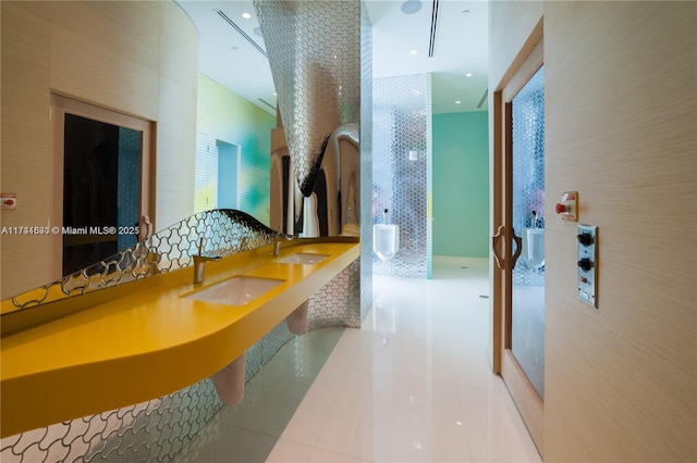 hall featuring tile patterned flooring, a sink, and recessed lighting