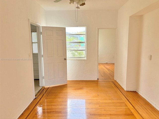 empty room featuring hardwood / wood-style floors and ceiling fan