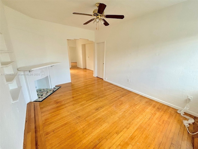 unfurnished living room with ceiling fan and light wood-type flooring