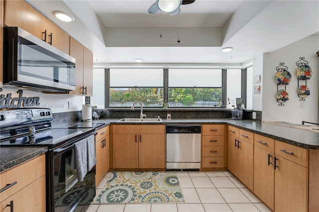 kitchen featuring sink, light tile patterned floors, appliances with stainless steel finishes, kitchen peninsula, and dark stone counters