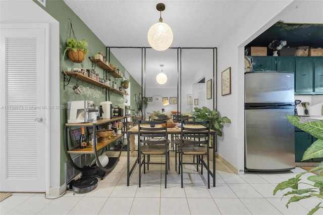 dining room with light tile patterned floors and a textured ceiling