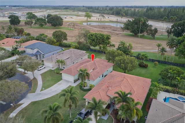 drone / aerial view featuring a residential view and a water view