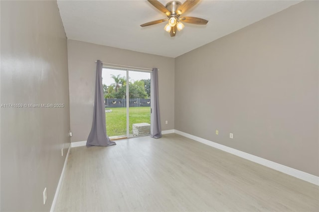 unfurnished room with a ceiling fan, light wood-style flooring, and baseboards