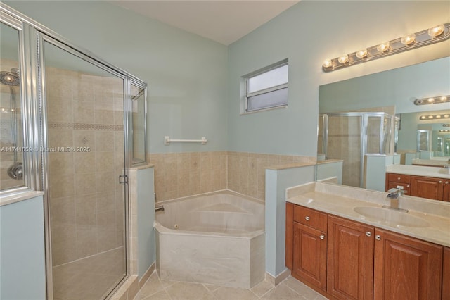 full bath with a stall shower, vanity, a garden tub, and tile patterned floors