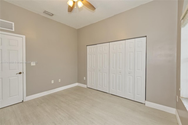 unfurnished bedroom featuring a ceiling fan, light wood-type flooring, visible vents, and baseboards