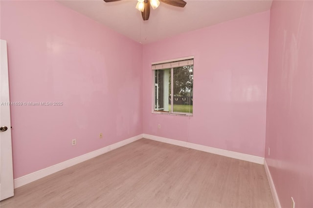 spare room featuring ceiling fan, wood finished floors, and baseboards