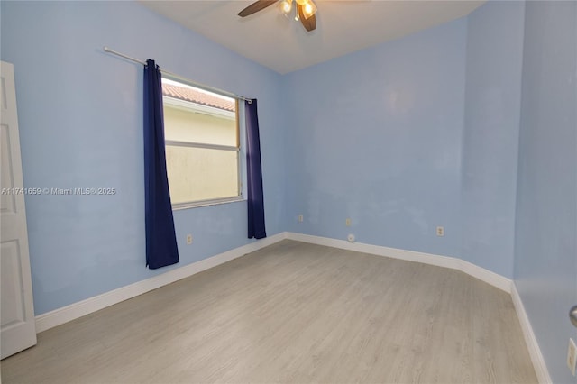 empty room featuring ceiling fan, wood finished floors, and baseboards