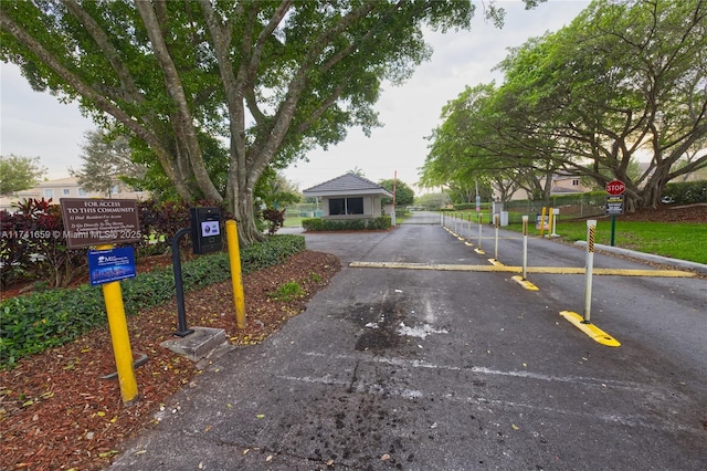 view of street featuring a gated entry and traffic signs