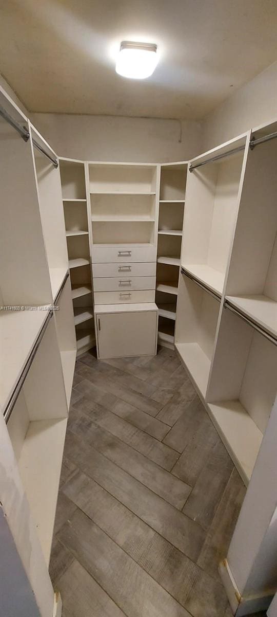 spacious closet featuring hardwood / wood-style flooring