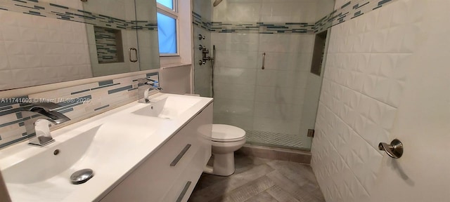 bathroom featuring tile walls, vanity, walk in shower, toilet, and tasteful backsplash