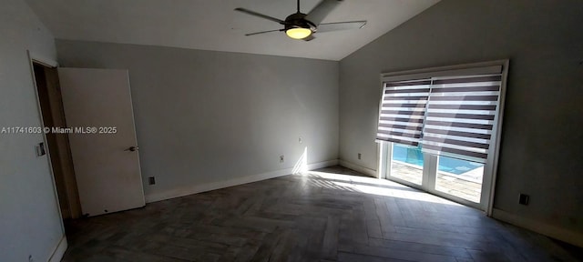 spare room featuring vaulted ceiling, ceiling fan, and dark parquet floors