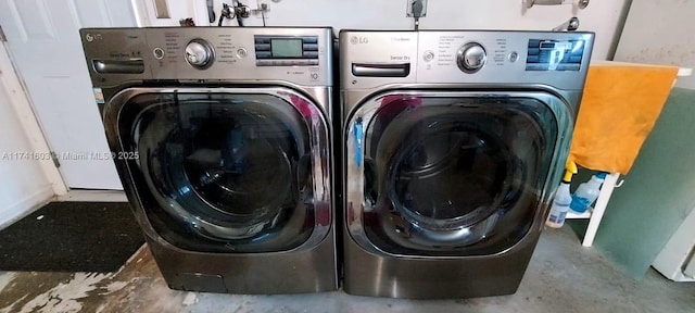 clothes washing area with washer and clothes dryer