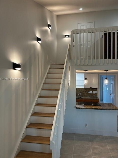 stairs with tile patterned flooring