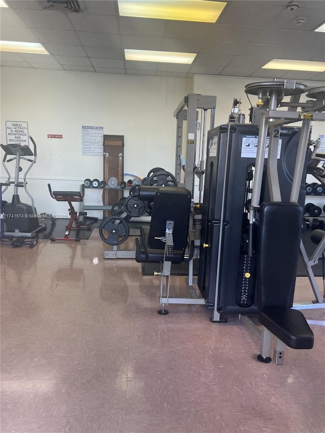 workout area featuring a paneled ceiling