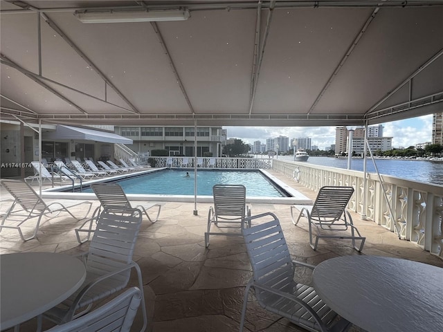 view of swimming pool featuring a water view