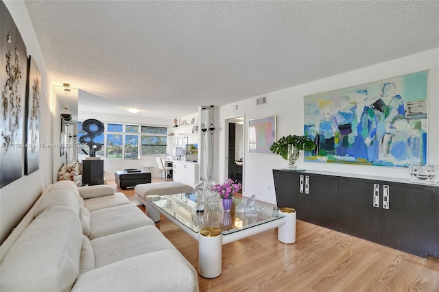 living room with hardwood / wood-style floors and a textured ceiling