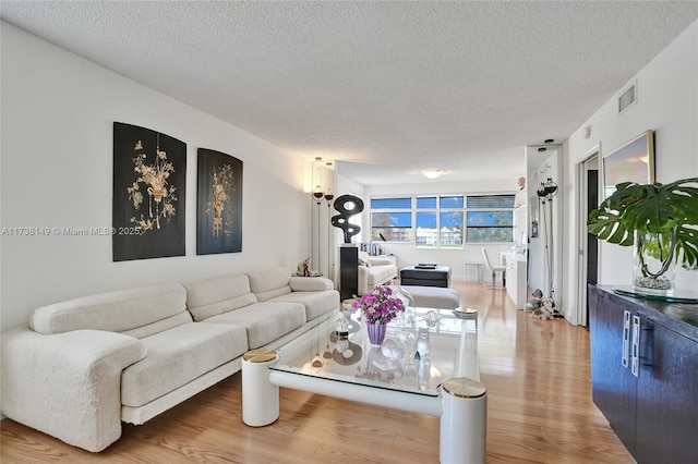 7368 Devon Dr Unit 301, Tamarac, FL 33321 - living room featuring hardwood / wood-style flooring and a textured ceiling