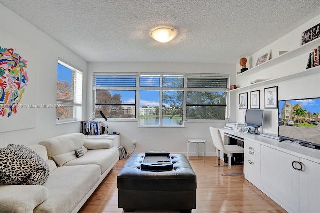7368 Devon Dr Unit 301, Tamarac, FL 33321 - living room featuring built in desk, light hardwood / wood-style floors, and a textured ceiling