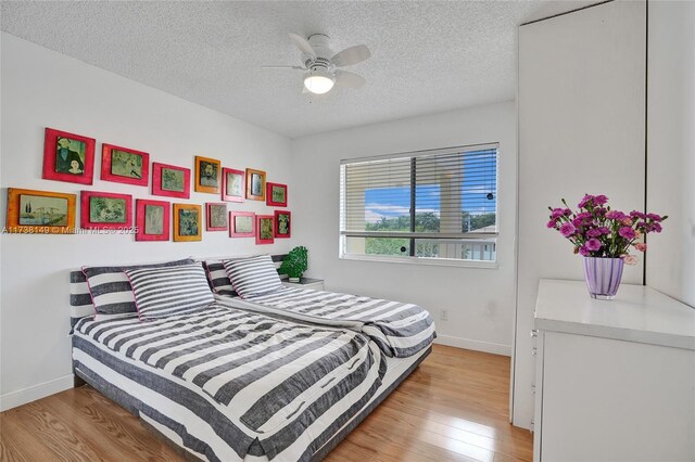 7368 Devon Dr Unit 301, Tamarac, FL 33321 - bedroom with ceiling fan, light hardwood / wood-style floors, and a textured ceiling