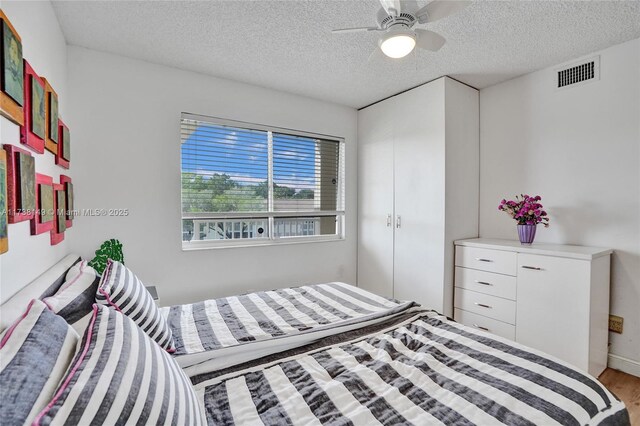 7368 Devon Dr Unit 301, Tamarac, FL 33321 - bedroom with ceiling fan, a textured ceiling, and light hardwood / wood-style floors