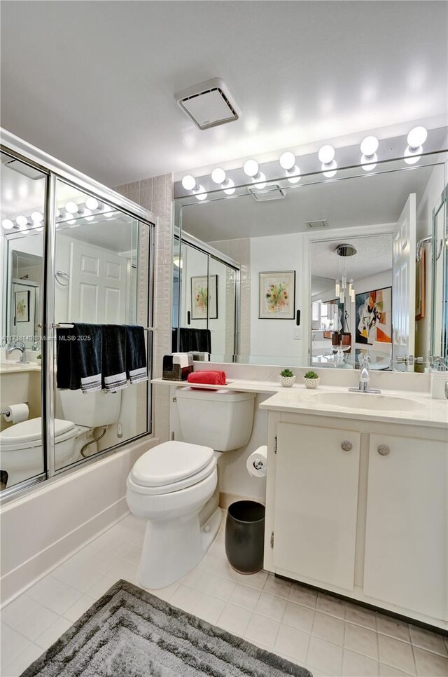 7368 Devon Dr Unit 301, Tamarac, FL 33321 - full bathroom featuring toilet, vanity, bath / shower combo with glass door, and tile patterned flooring