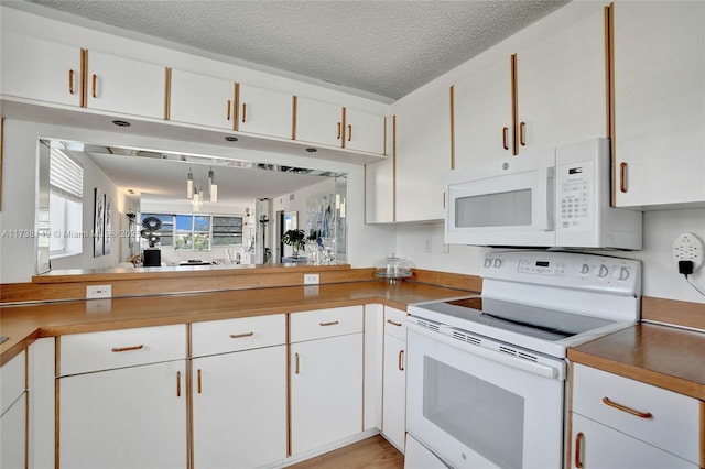 7368 Devon Dr Unit 301, Tamarac, FL 33321 - kitchen featuring white cabinetry, white appliances, and a textured ceiling