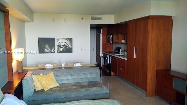 living room featuring sink and dark tile patterned floors