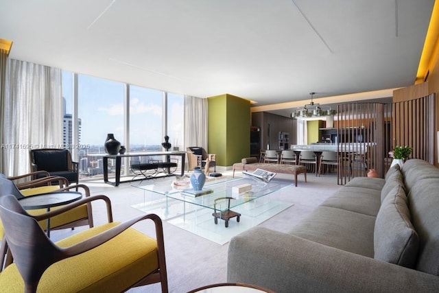 living room with carpet, floor to ceiling windows, and a notable chandelier