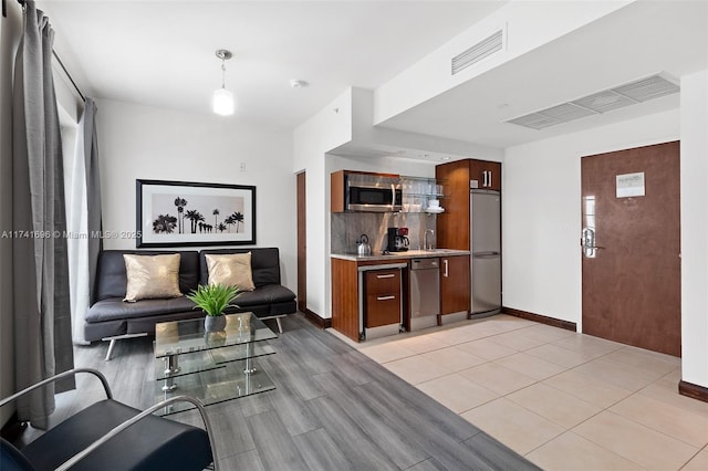 living room with light tile patterned floors and sink