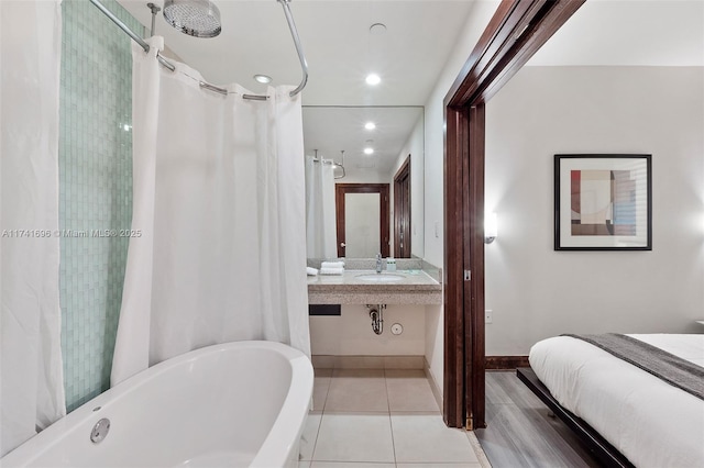 bathroom featuring tile patterned floors, sink, and shower / bath combo with shower curtain