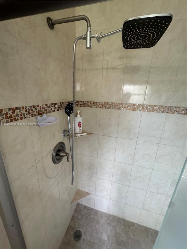 bathroom with a tile shower