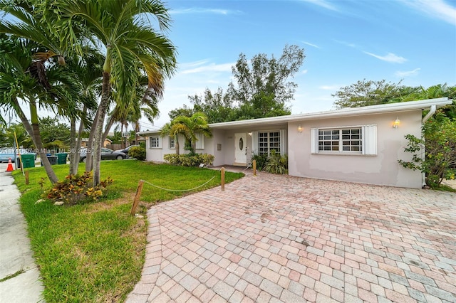 ranch-style home featuring a front lawn