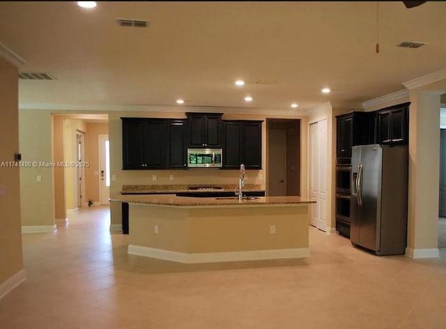 kitchen featuring sink, crown molding, a kitchen island with sink, stainless steel appliances, and a kitchen breakfast bar