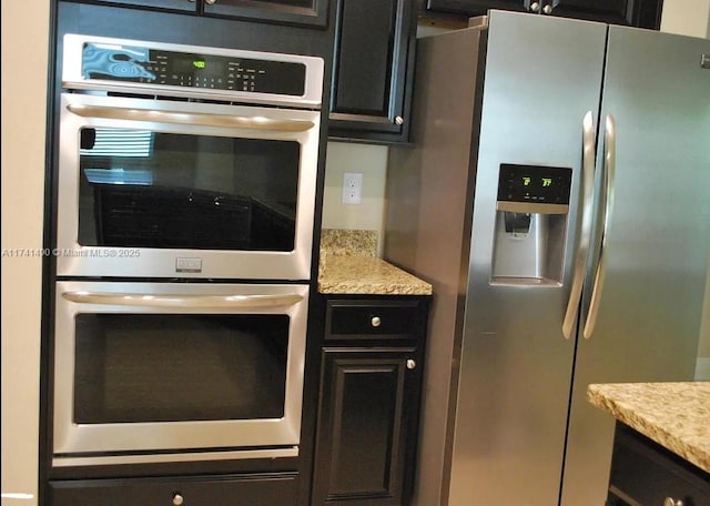 kitchen with light stone countertops and stainless steel appliances