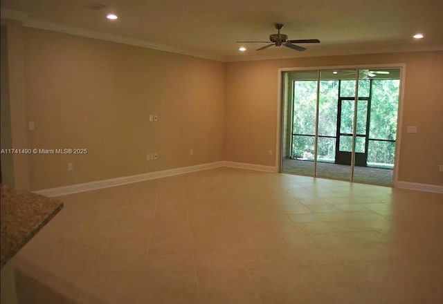 spare room with ornamental molding and ceiling fan