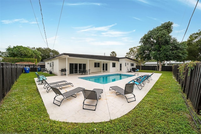 view of pool with a lawn and a patio