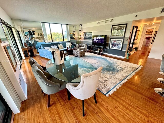 3850 Washington St Unit 317, Hollywood, FL 33021 - dining room with light hardwood / wood-style flooring and a textured ceiling