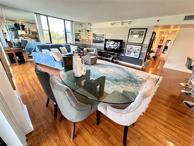 3850 Washington St Unit 317, Hollywood, FL 33021 - dining room with hardwood / wood-style floors, track lighting, and a textured ceiling
