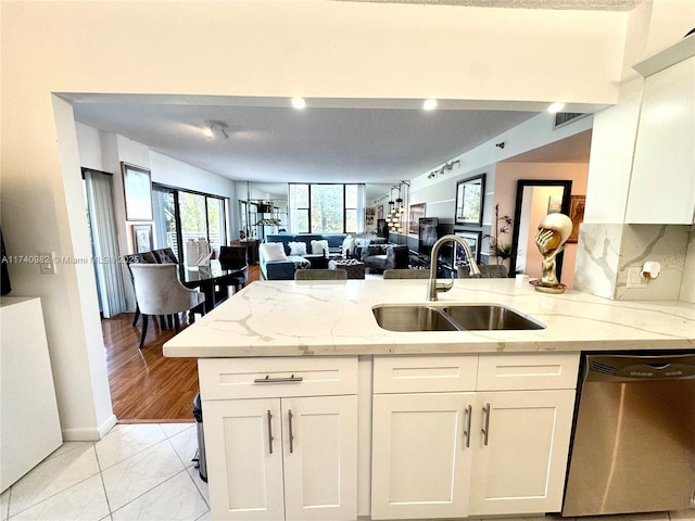 3850 Washington St Unit 317, Hollywood, FL 33021 - kitchen featuring sink, light stone counters, stainless steel dishwasher, decorative backsplash, and white cabinets