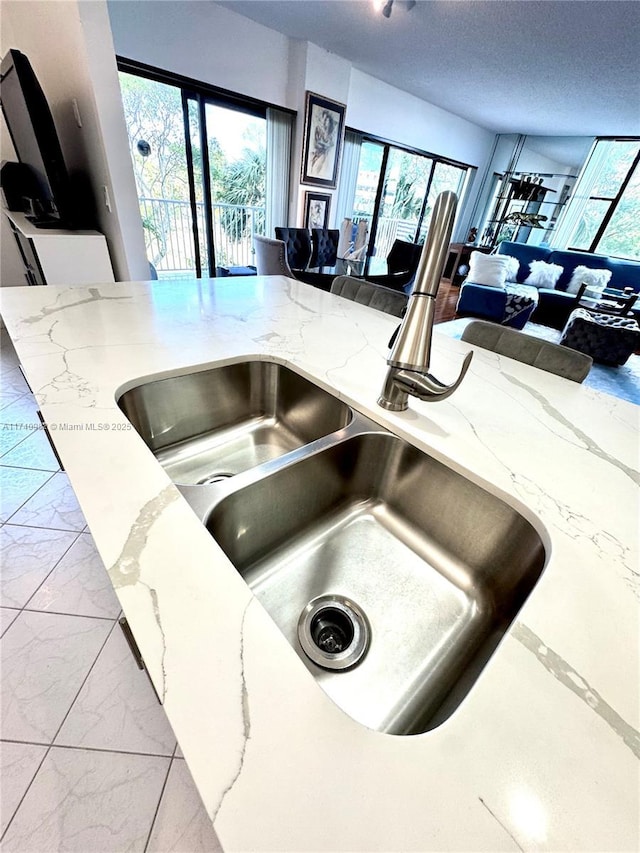 3850 Washington St Unit 317, Hollywood, FL 33021 - interior details featuring sink, a textured ceiling, and light stone counters