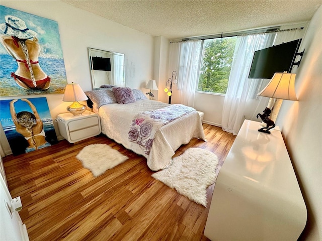 3850 Washington St Unit 317, Hollywood, FL 33021 - bedroom with a textured ceiling and light hardwood / wood-style floors