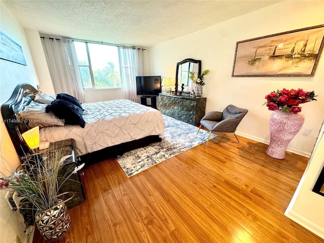 3850 Washington St Unit 317, Hollywood, FL 33021 - bedroom featuring hardwood / wood-style flooring and a textured ceiling