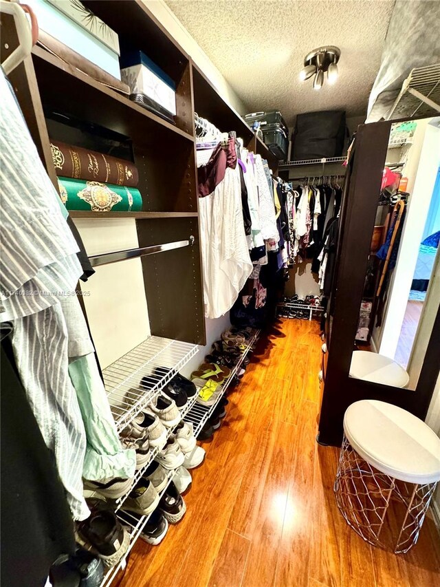 3850 Washington St Unit 317, Hollywood, FL 33021 - spacious closet featuring hardwood / wood-style floors