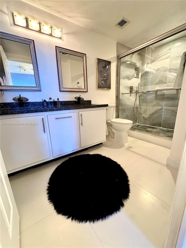 3850 Washington St Unit 317, Hollywood, FL 33021 - bathroom with walk in shower, tile patterned floors, vanity, and toilet