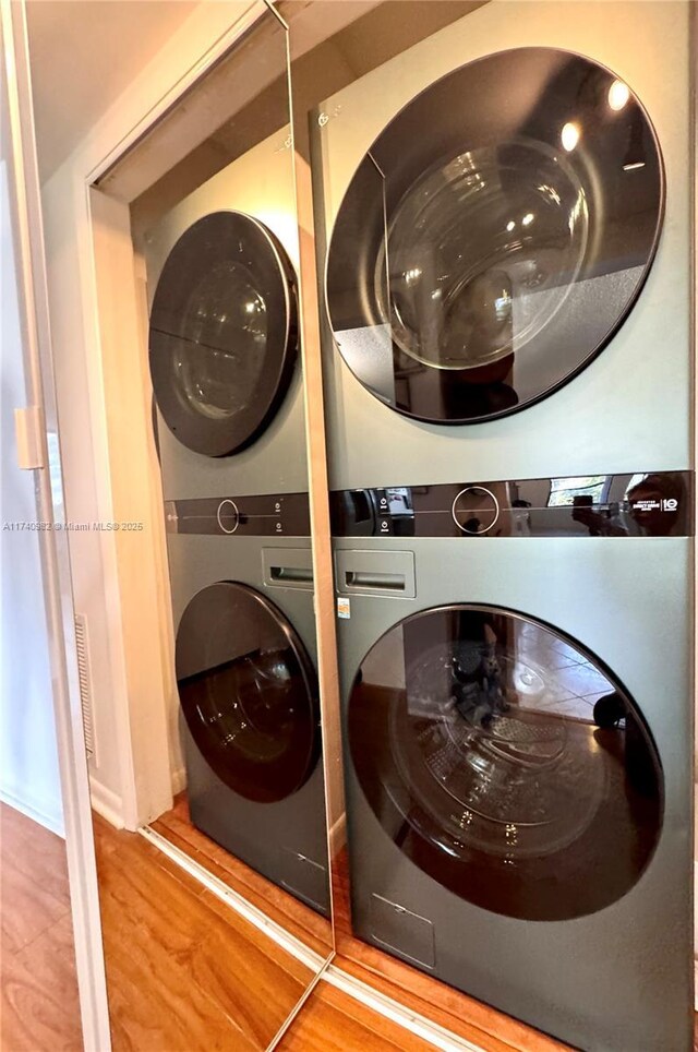 3850 Washington St Unit 317, Hollywood, FL 33021 - washroom with hardwood / wood-style flooring and stacked washer and clothes dryer