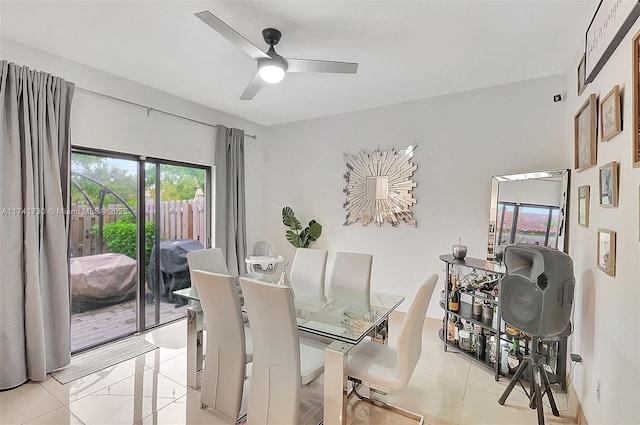 dining space with ceiling fan and light tile patterned floors