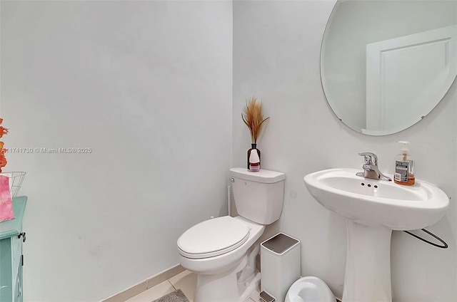 bathroom featuring tile patterned flooring and toilet