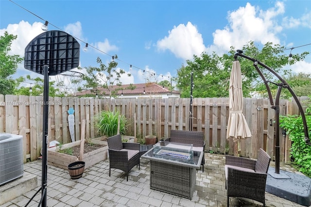 view of patio / terrace featuring central AC and an outdoor fire pit